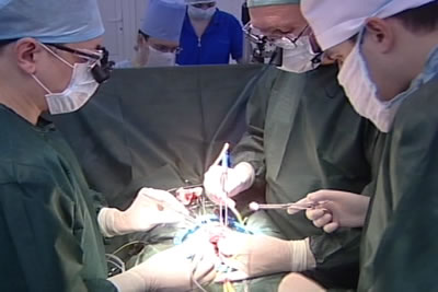 Оператор и его ассистент работают с использованием специальных налобных увеличительных луп